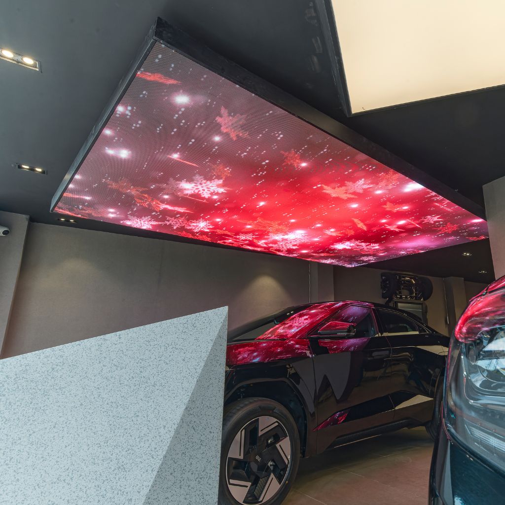 Aleda LED digital ceiling panel over a car.